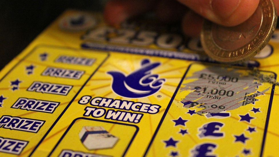 Lottery scratchcard being scratched