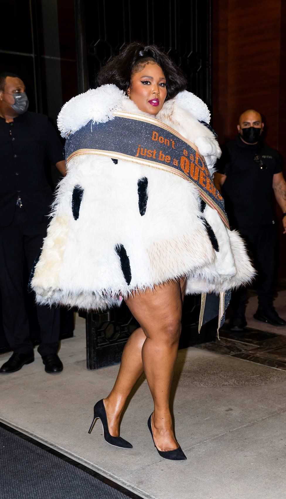 Lizzo wearing a faux ermine dress with a sash which is embroidered with the words: 'Don't be a drag, be a queen' by Viktor & Rolf (New York, 2021).