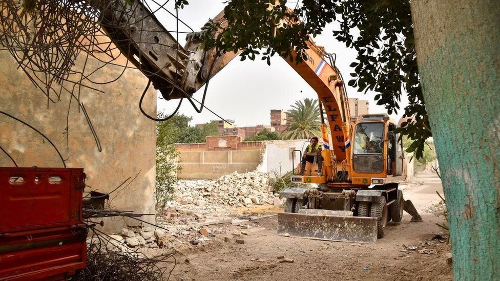 A bulldozer demolishing a tomb in the centuries-old Sayyida Nafisa cemetery