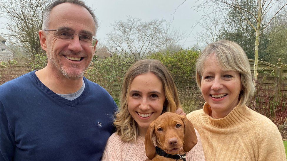 Mark Simmonds pictured with daughter Emily holding dog Peggy, and wife and business partner Mel, 57.