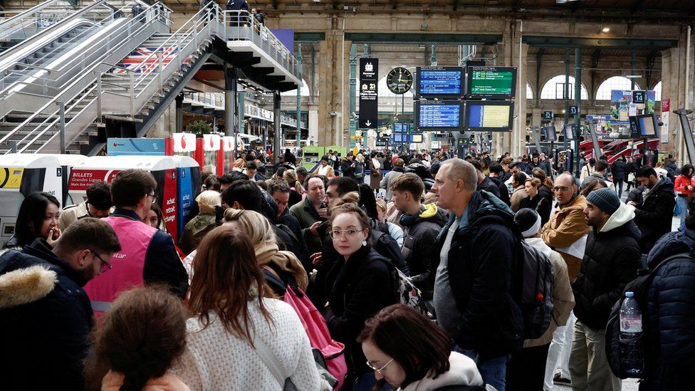 Passengers queue at the departure gates of the Eurostar terminal at Gare du Nord train station.