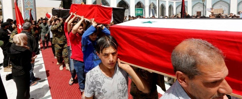 Mourners with coffins in Damascus