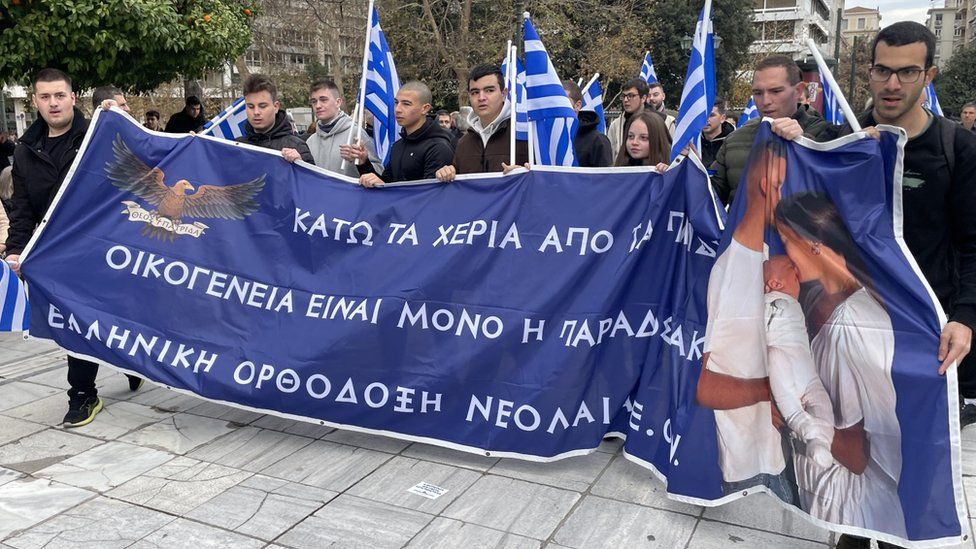 Protesters outside the Greek parliament hold a banner that reads "Take your hands off our kids. There's only one family, the traditional one."