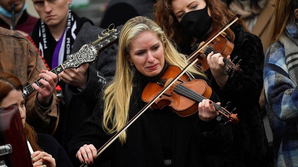 A musician plays in tribute to Ashling Murphy