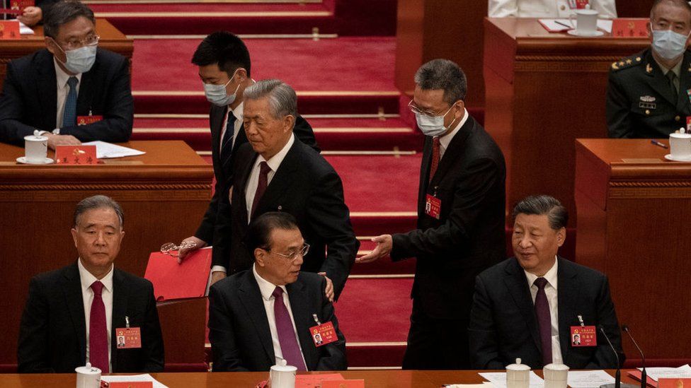 Xi Jinping and Premier Li Keqiang look on as former President Hu Jintao is escorted out of the Communist Party Congress.