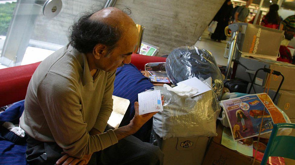 Mehran Karimi Nasseri pictured with his possessions in Charles de Gaulle airport in 2004