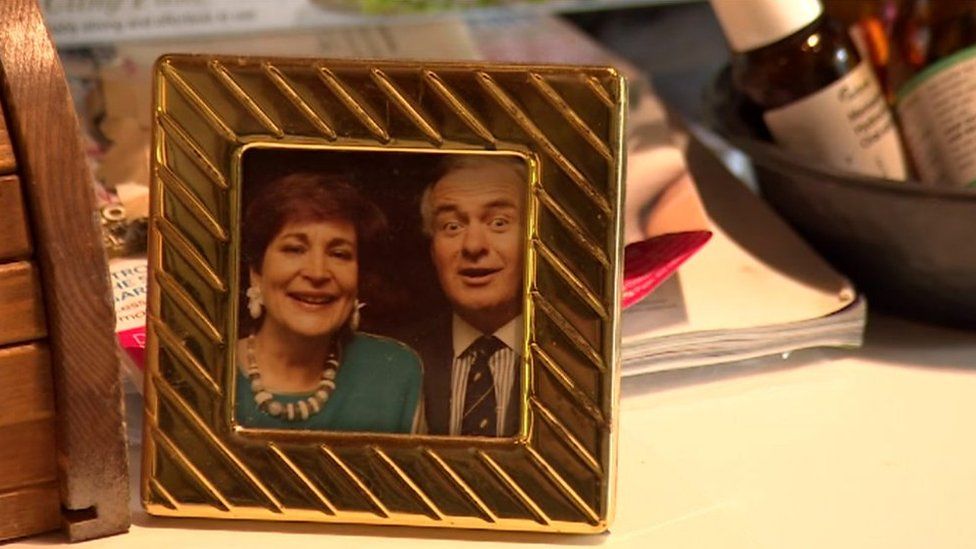 A framed photo of David Parry-Jones and Beti George