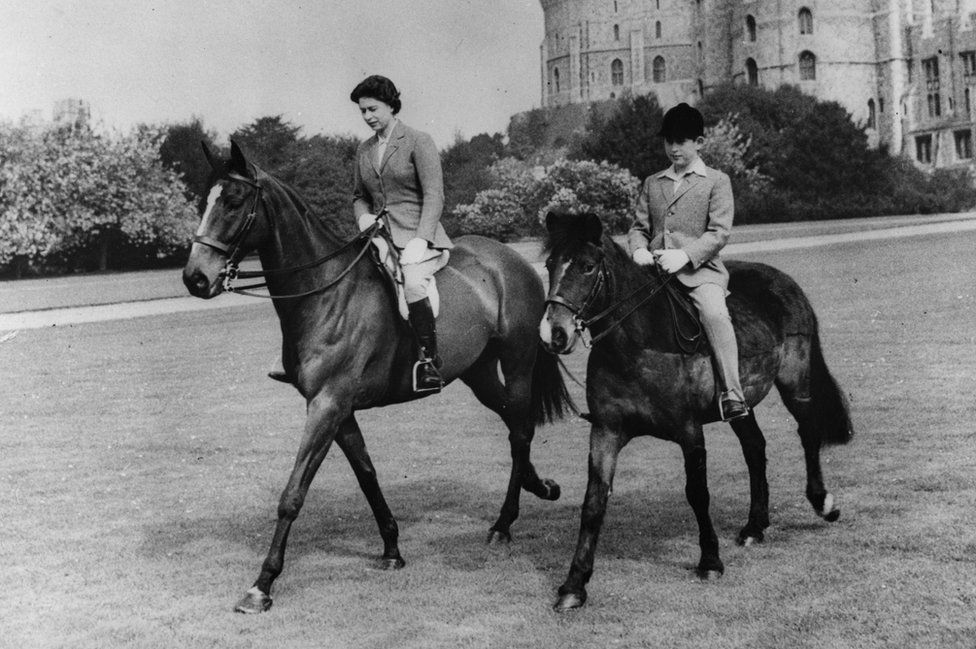 Queen Elizabeth II and her son, Prince Charles, out riding at Windsor Castle
