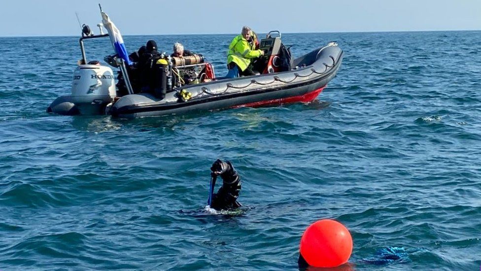 Divers marking the site of the wreck