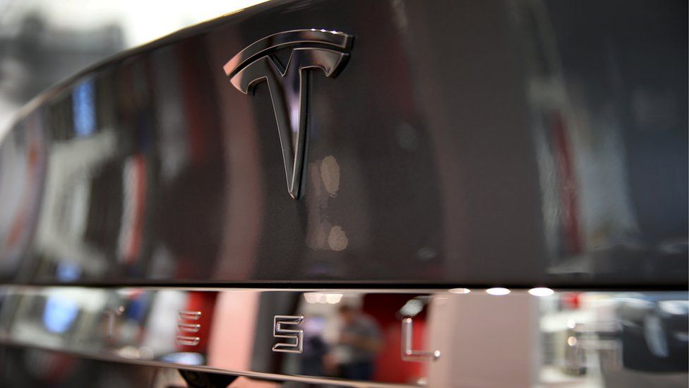 Image of Tesla badge on boot of car