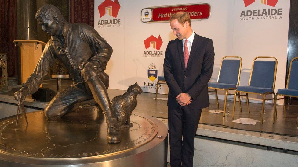 Prince William, Duke of Cambridge looks at the statue of Captain Flinders cat 'Trim' as he unveils a statue in honour of Captain Matthew Flinders, the first cartographer to circumnavigate Australia and identify it as a continent, at Australia House on July 18, 2014 in London, England
