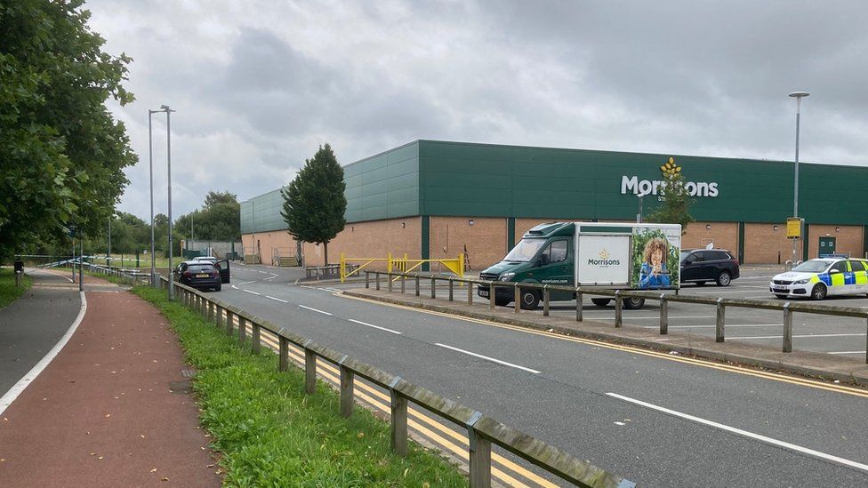 A section of the pavement to the left of the supermarket was taped off by police