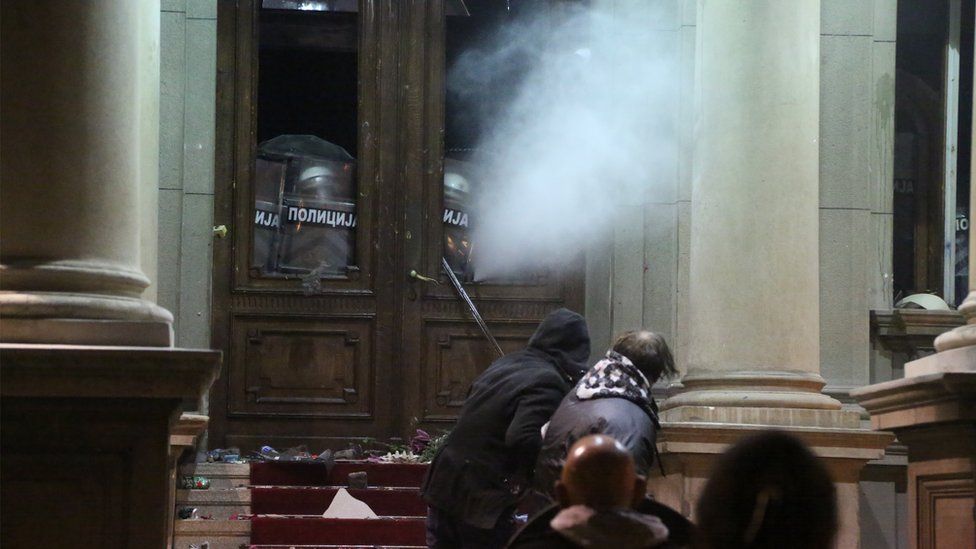Serbian police fire tear gas against protesters who try to break into Belgrade City Hall. Photo: 24 December 2023