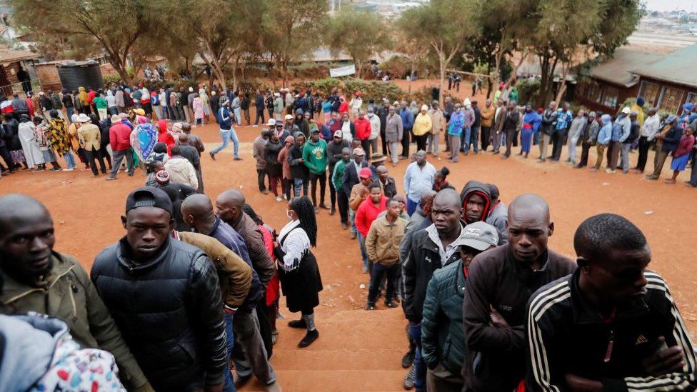 Voters queue before casting their ballots during the general election by the Independent Electoral and Boundaries Commission (IEBC) in Mashimoni village of Kibera slums of Nairobi, Kenya August 9, 2022