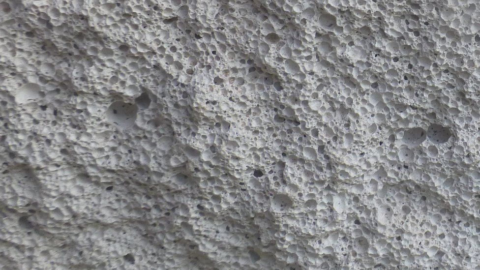 File image showing the surface of aerated concrete, with lots of air bubbles