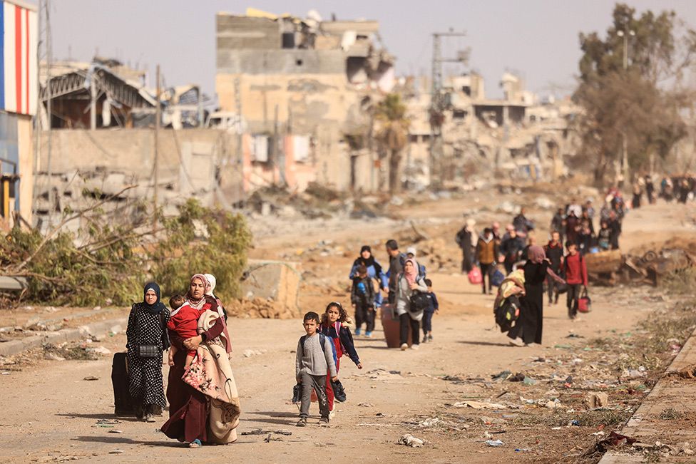 Palestinians fleeing the north walk along the Salaheddine road in the Zeitoun district on the southern outskirts of Gaza City - 26 November 2023