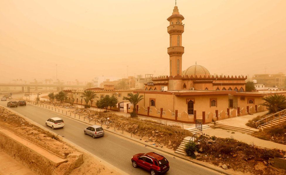 Motorists drive their vehicles through a sandstorm in Libya's eastern city of Benghazi - 22 April 2024