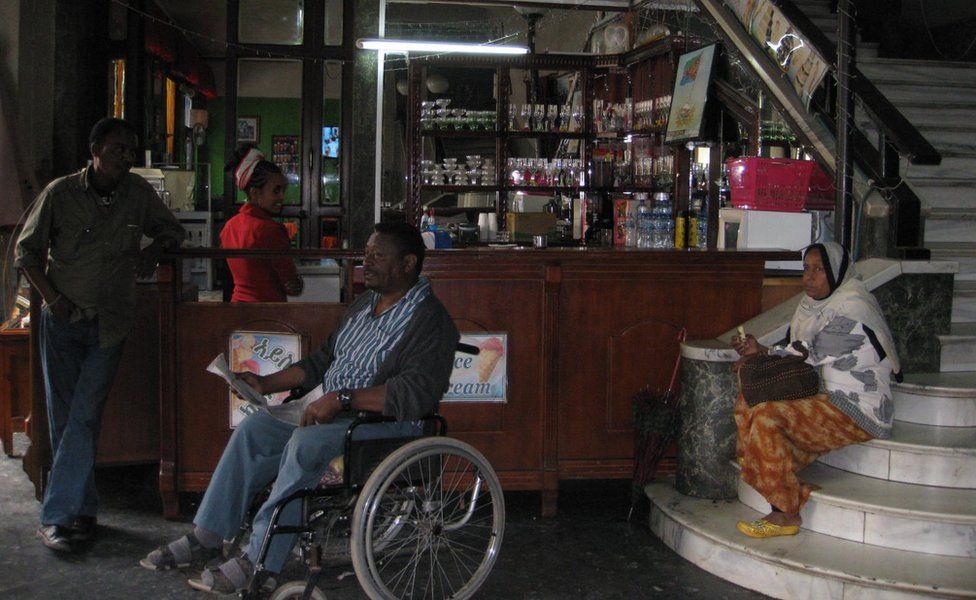 Disabled people socialising in the foyer of the Cinema Imperio