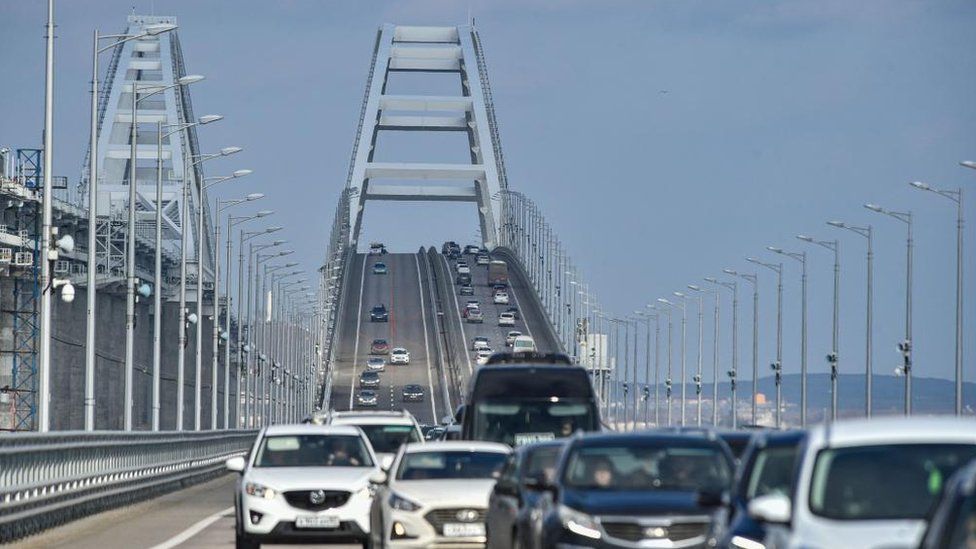 Traffic crosses over the Crimea Bridge. There are two lanes in either direction.