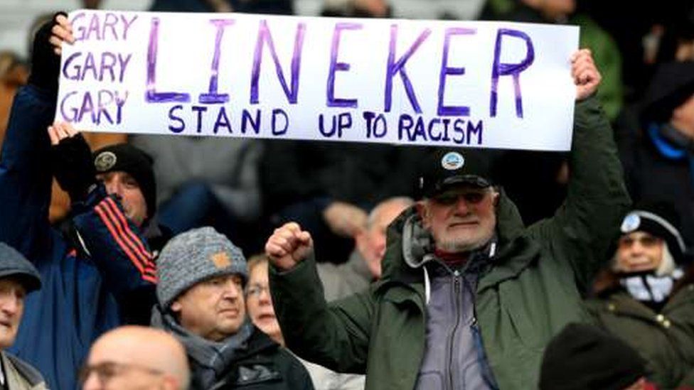 Fans at Swansea City ground holding up placard in support of Gary Lineker
