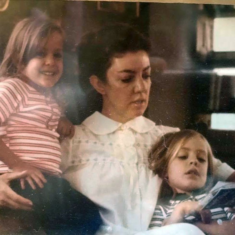 Alejandra Rueda (right) reading with her mother and sister as a child