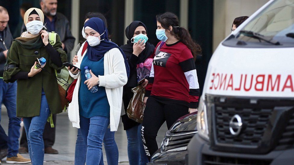 people outside Beirut hospital where the virus patient is being treated