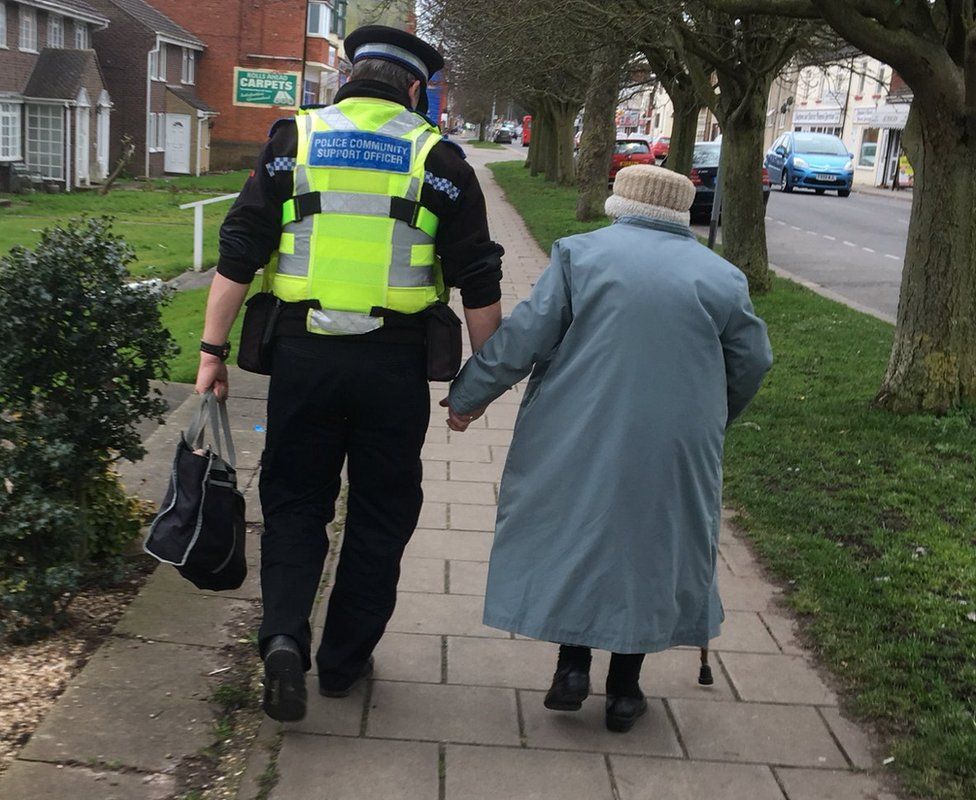 PCSO Dave Bunker helps and elderly woman