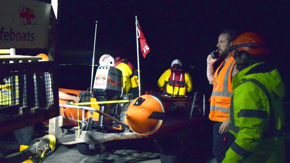 Volunteer crews on a lifeboat in hi-vis jackets
