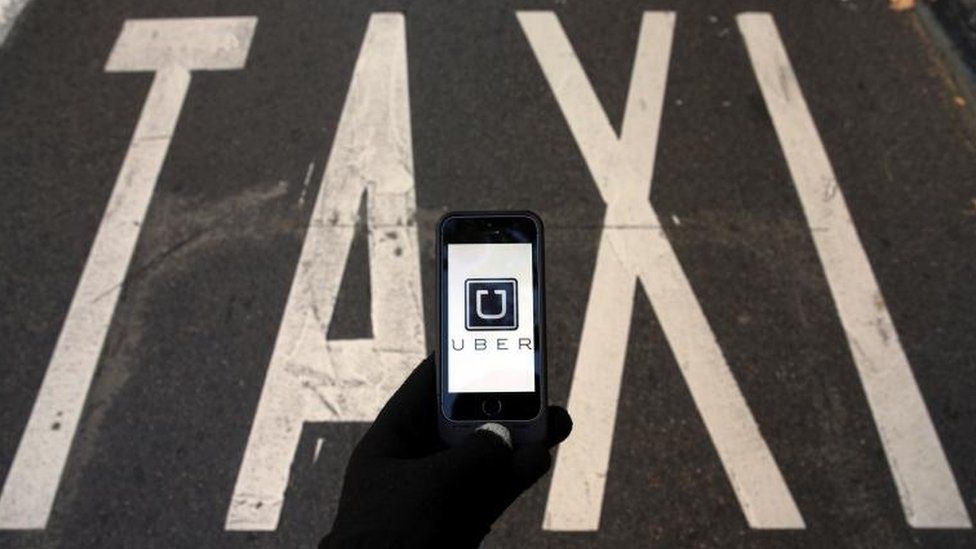 Taxi sign and Uber logo