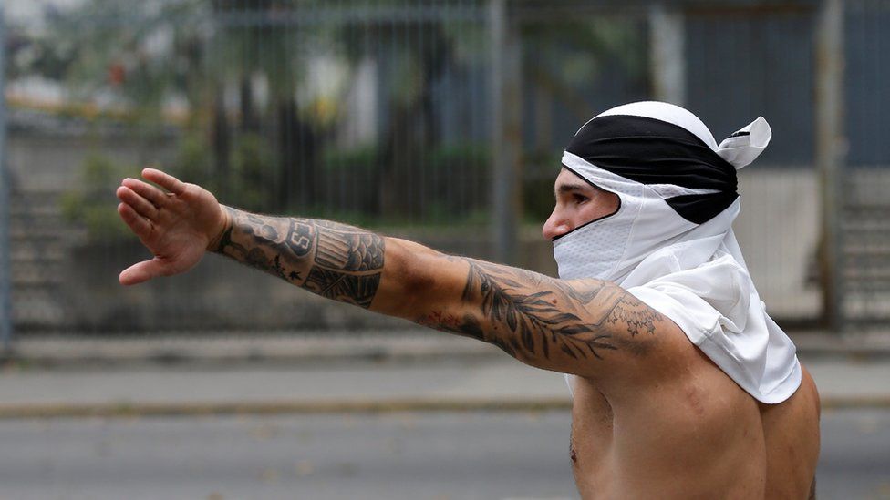 A demonstrator gestures during a rally against Venezuelan President Nicolas Maduro in Caracas, 20 April 2017