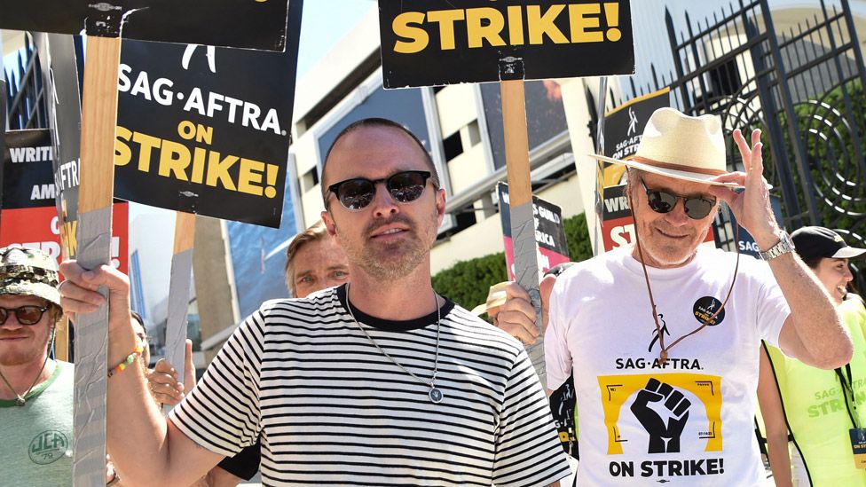 US actors Bryan Cranston and Aaron Paul join the Screen Actors Guild (SAG-AFTRA) picket line in front of Sony Pictures Entertainment Studios in Culver City, California, on August 29, 2023