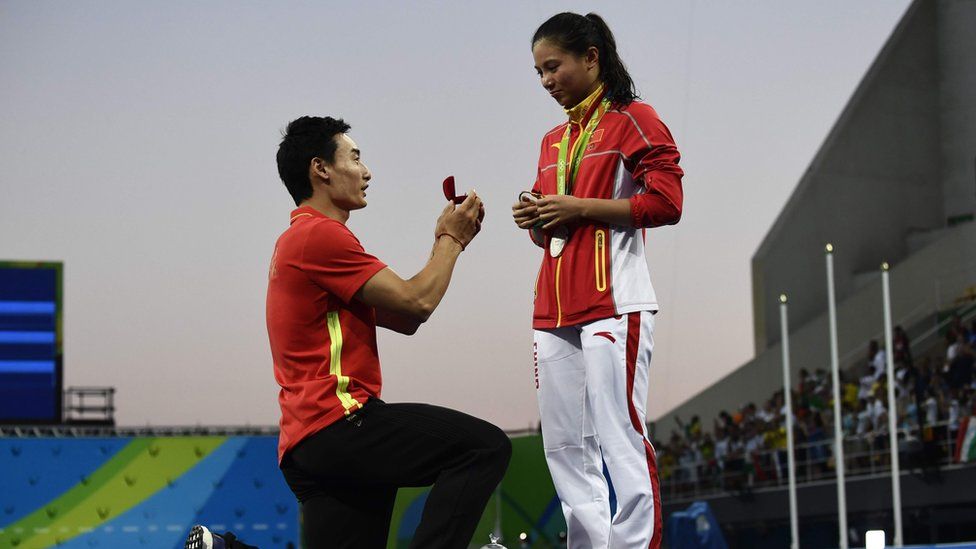 Silver medallist China's He Zi reacts as she receives a marriage proposal from Chinese diver Qin Kai