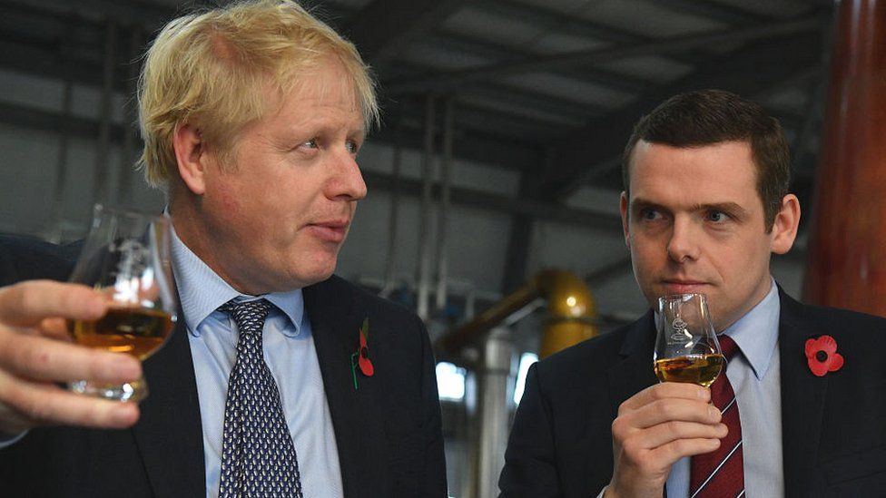 Boris Johnson tastes whisky with Douglas Ross during a general election campaign visit in November 2019