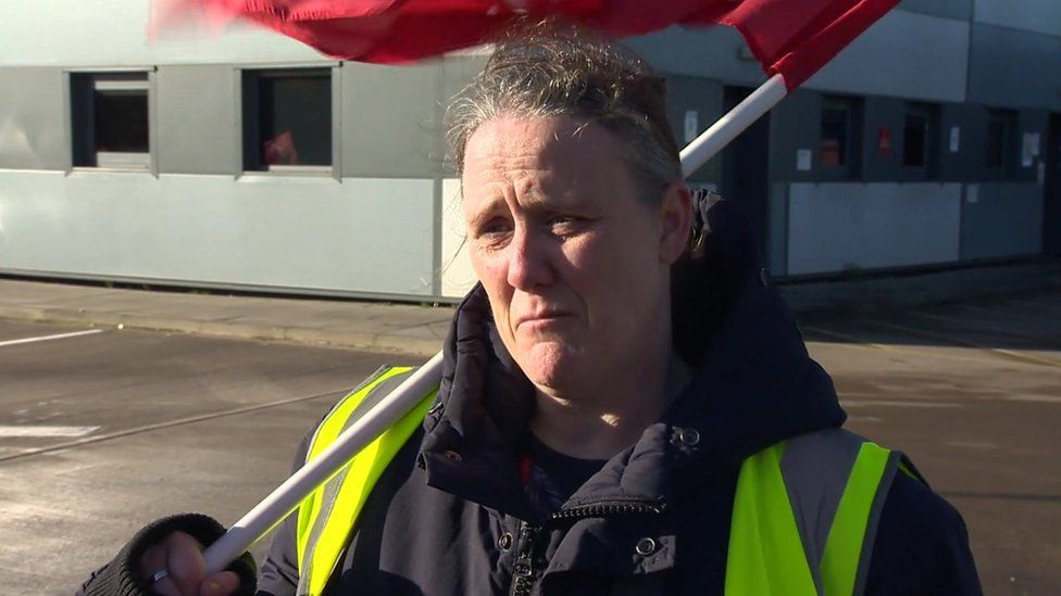 Bus driver Anne-Marie Gothriley holding union flag
