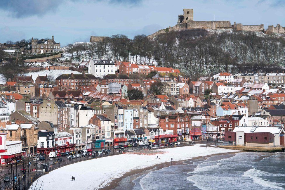 Snow covers the beach in the sea side resort of Scarborough in North Yorkshire