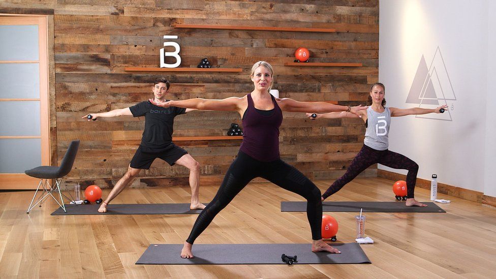 Two women and a man in exercise studio