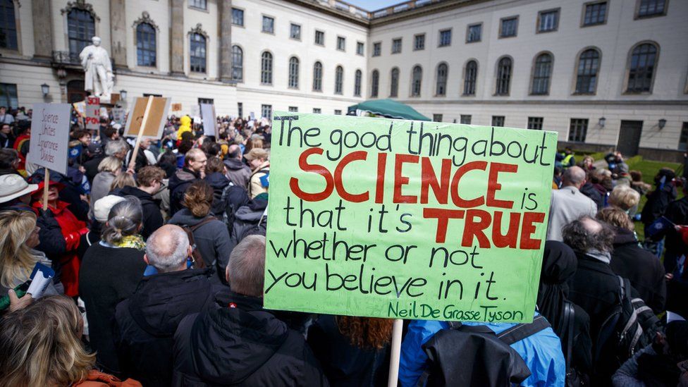 Demonstrators hold banners before the March for Science in front of the Humboldt University in Berlin, Germany, 22 April 2017