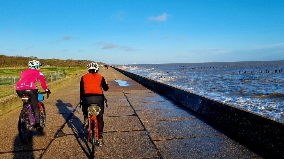 Cyclists riding along the East coast of Suffolk
