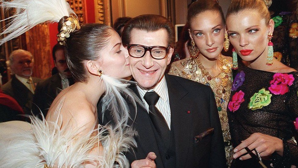 Yves Saint Laurent pictured with models in January 2000