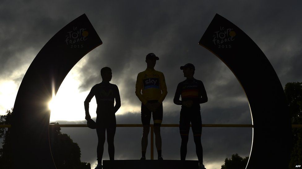 Tour de France 2015's winner Christopher Froome (C), second-placed Colombia's Nairo Quintana (L) and third-placed Spain's Alejandro Valverde (R) stand on the podium on the Champs-Elysees avenue in Paris, at the end of the cycling race on 26 July 2015