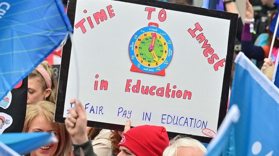 A sign that reads: Time to invest in education. Fair pay in education