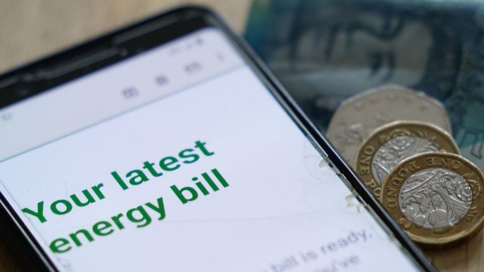 Generic energy bill on a mobile phone screen and some cash