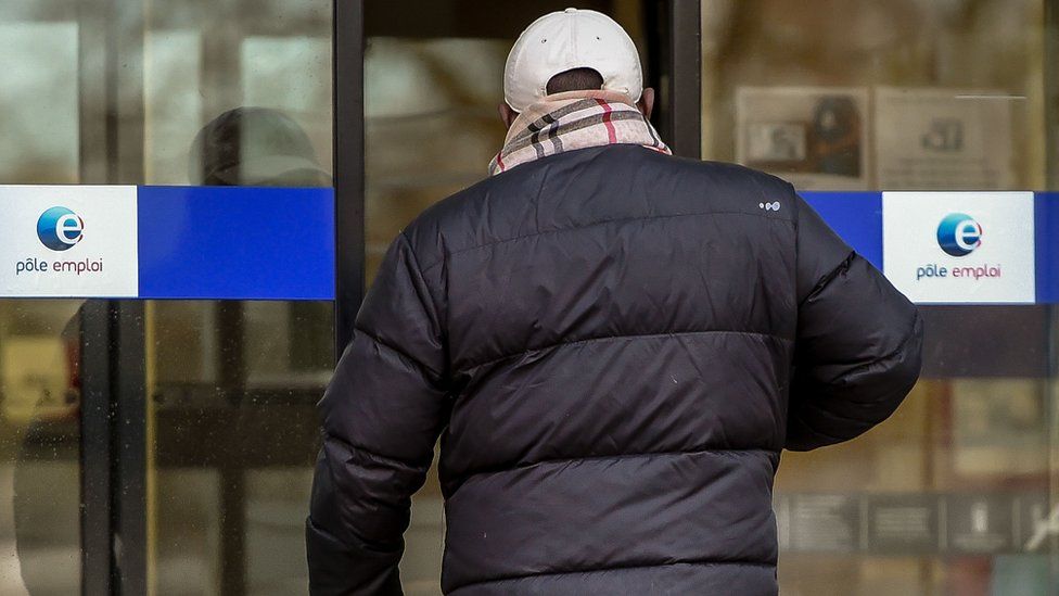 File pic of man entering Pôle emploi agency in France