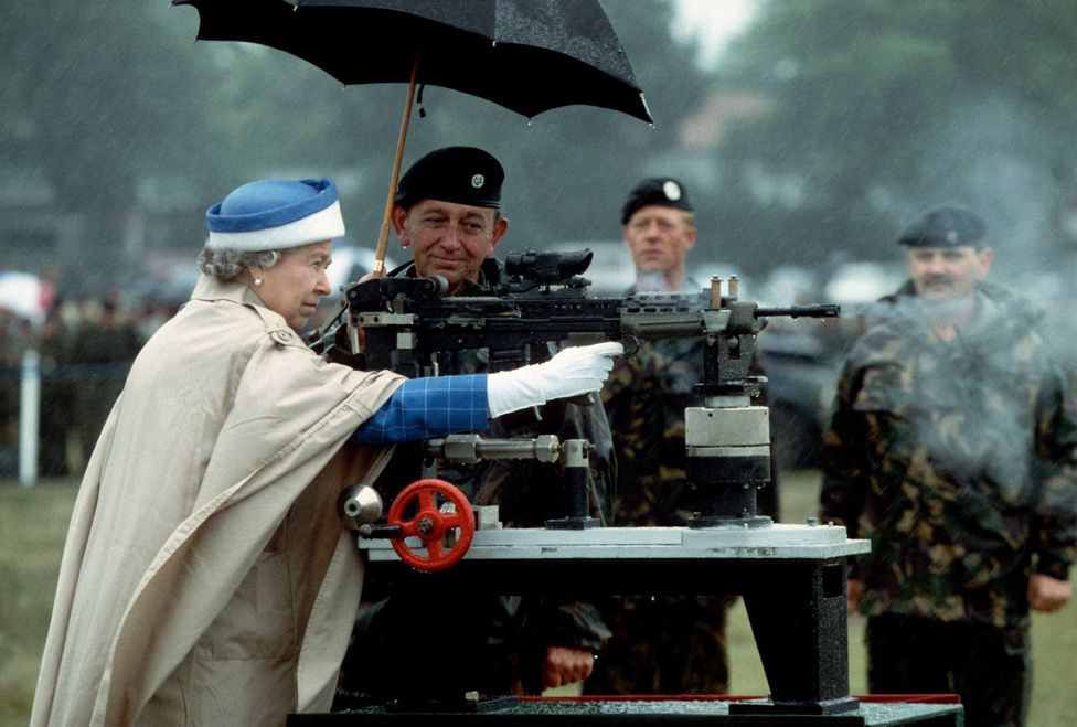 HM Queen Elizabeth II fires a rifle during a visit to the Army rifle association at Bisley, England July 1993