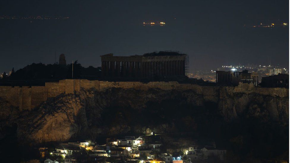 The ancient Parthenon temple is pictured atop the Acropolis Hill during Earth Hour in Athens, Greece
