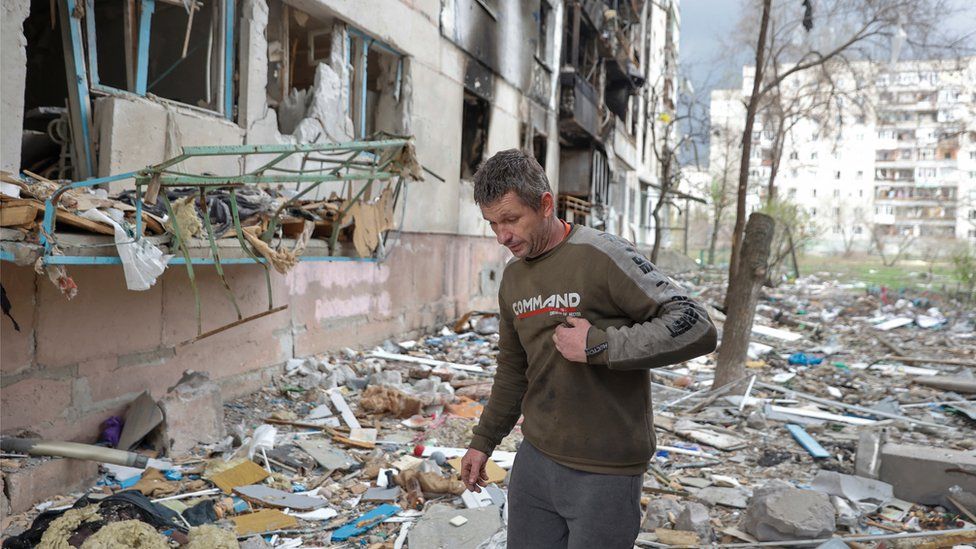 A civilian walks through rubble in Sievierodonetsk