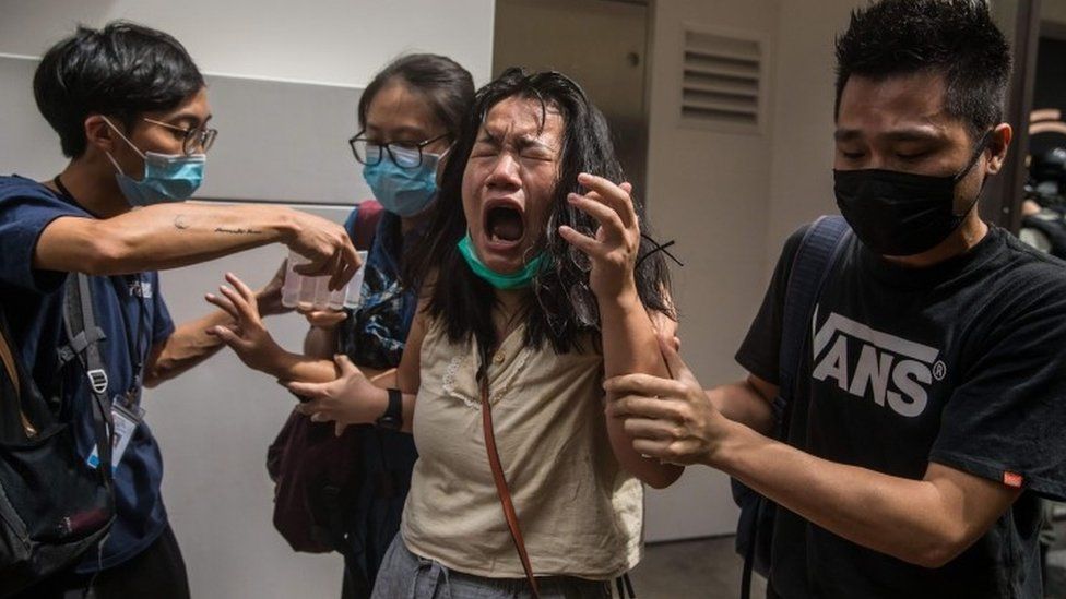 A woman hit with pepper spray during protests in Hong Kong on Wednesday