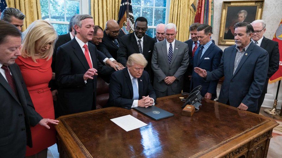 President Trump prays with faith leaders in the Oval Office