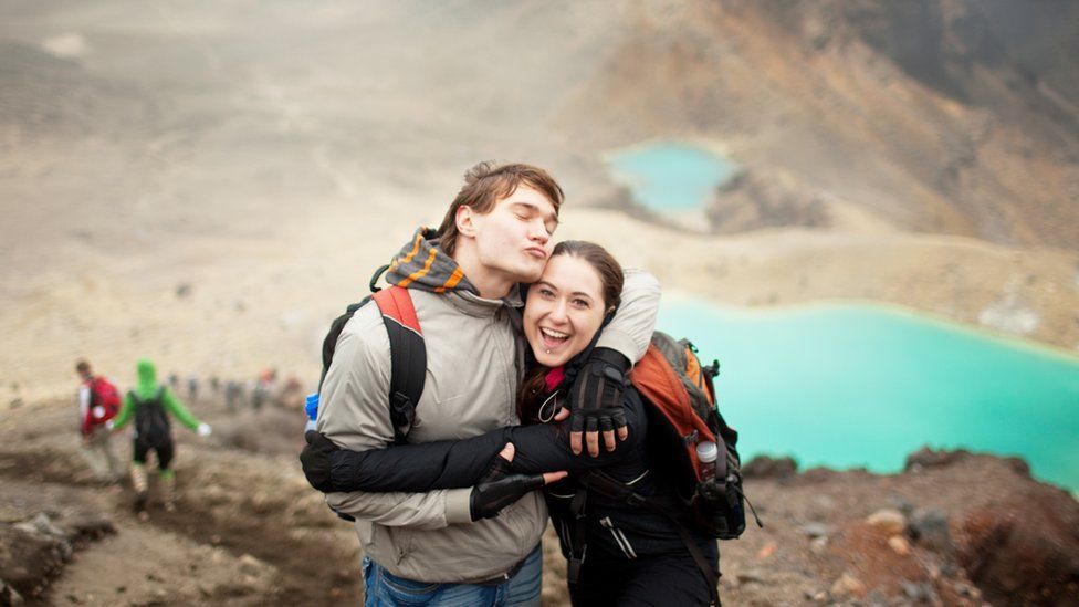 A happy couple at Tongariro Alpine Crossing, a popular tourist attraction in New Zealand.