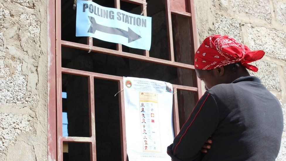 A voter in Zambia looking at a list of candidates at a polling station in Lusaka